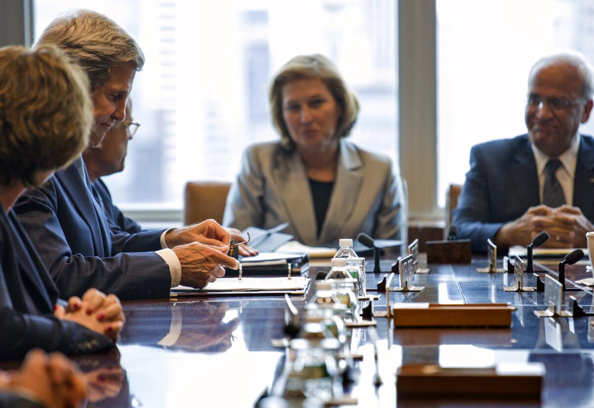 Palestinian negotiator Saeb Erekat, right, talks with U.S. Secretary of State John F. Kerry, left, and Israeli negotiator Tzipi Livni at the United Nations in New York.
