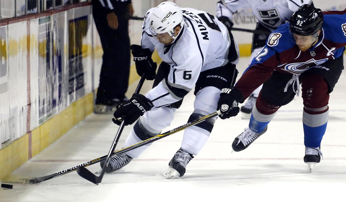 Kings defenseman Jake Muzzin beats Avalanche left wing Gabriel Landeskog to the puck along the boards during a preaseason game last week in Colorado Springs.