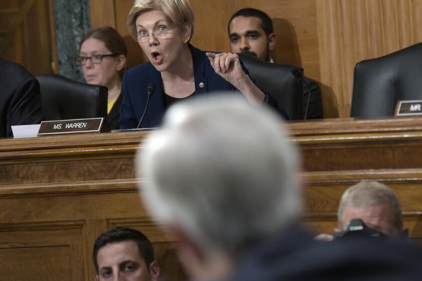 Sen. Elizabeth Warren (D-Mass.) questions Wells Fargo Chief Executive John Stumpf, foreground, during a Senate Banking Committee hearing Sept. 20. He retired last week.