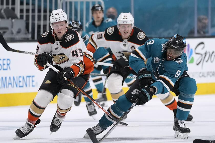 San Jose Sharks left wing Evander Kane (9) works for the puck against Anaheim Ducks center Danton Heinen (43) during the second period of an NHL hockey game Tuesday, April 6, 2021, in San Jose, Calif. (AP Photo/Tony Avelar)