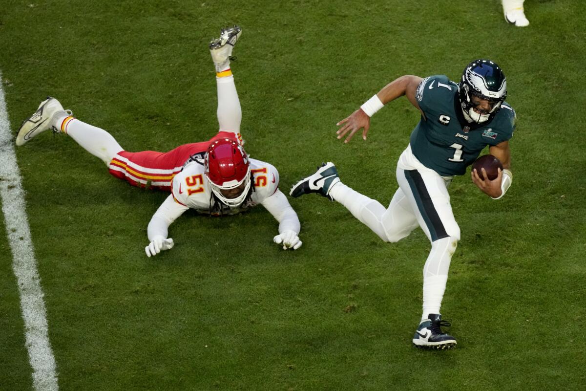 Philadelphia Eagles quarterback Jalen Hurts evades Kansas City Chiefs defensive end Mike Danna.