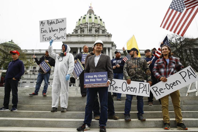 Protesters demonstrate at the state Capitol in Harrisburg, Pa., Monday, April 20.