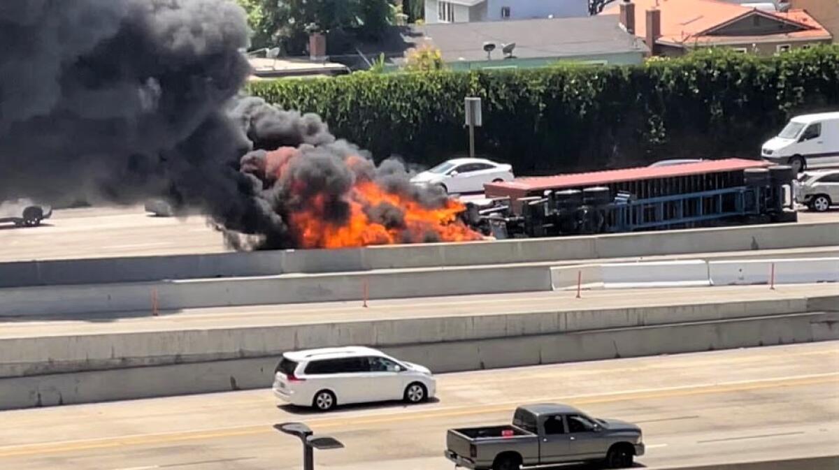 A big rig caught fire on the 405 Freeway Wednesday afternoon, the result of a five-car collision in Costa Mesa, injuring two.