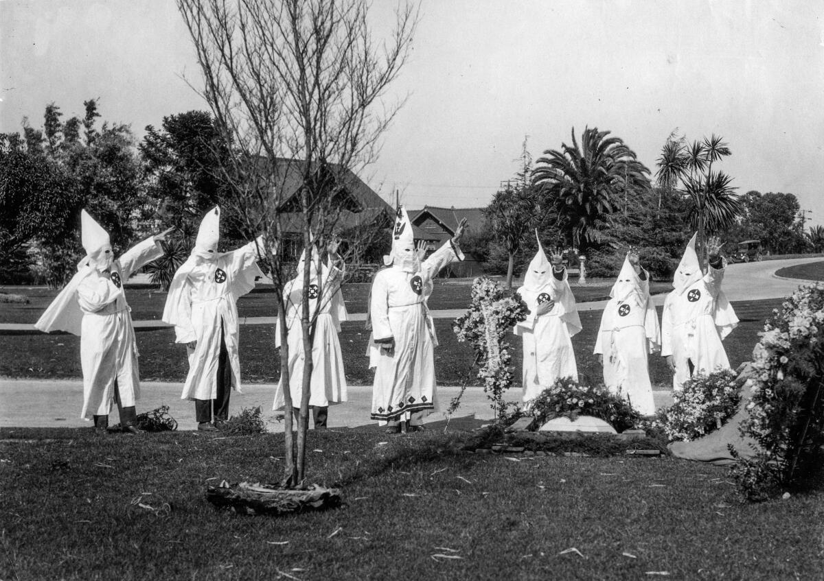 Black-and-white photo of members of the Ku Klux Klan at funeral services