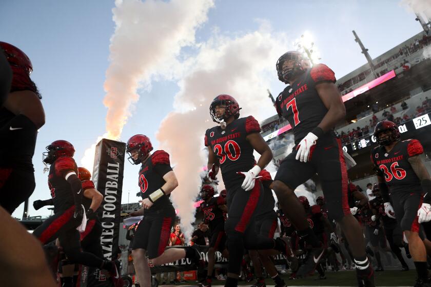 San Diego, CA - October 21: San Diego State players run out onto the field before their game against the Nevada Wolf Pack at Snapdragon Stadium on Saturday, Oct. 21, 2023 in San Diego, CA. (Meg McLaughlin / The San Diego Union-Tribune)