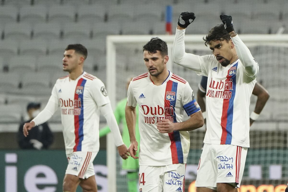 Lyon's Lucas Paqueta, right, celebrates after scoring his side's opening goal during the French League One soccer match between Lyon and Paris Saint-Germain in Lyon, France, Sunday, Jan. 9, 2022. (AP Photo/Laurent Cipriani)