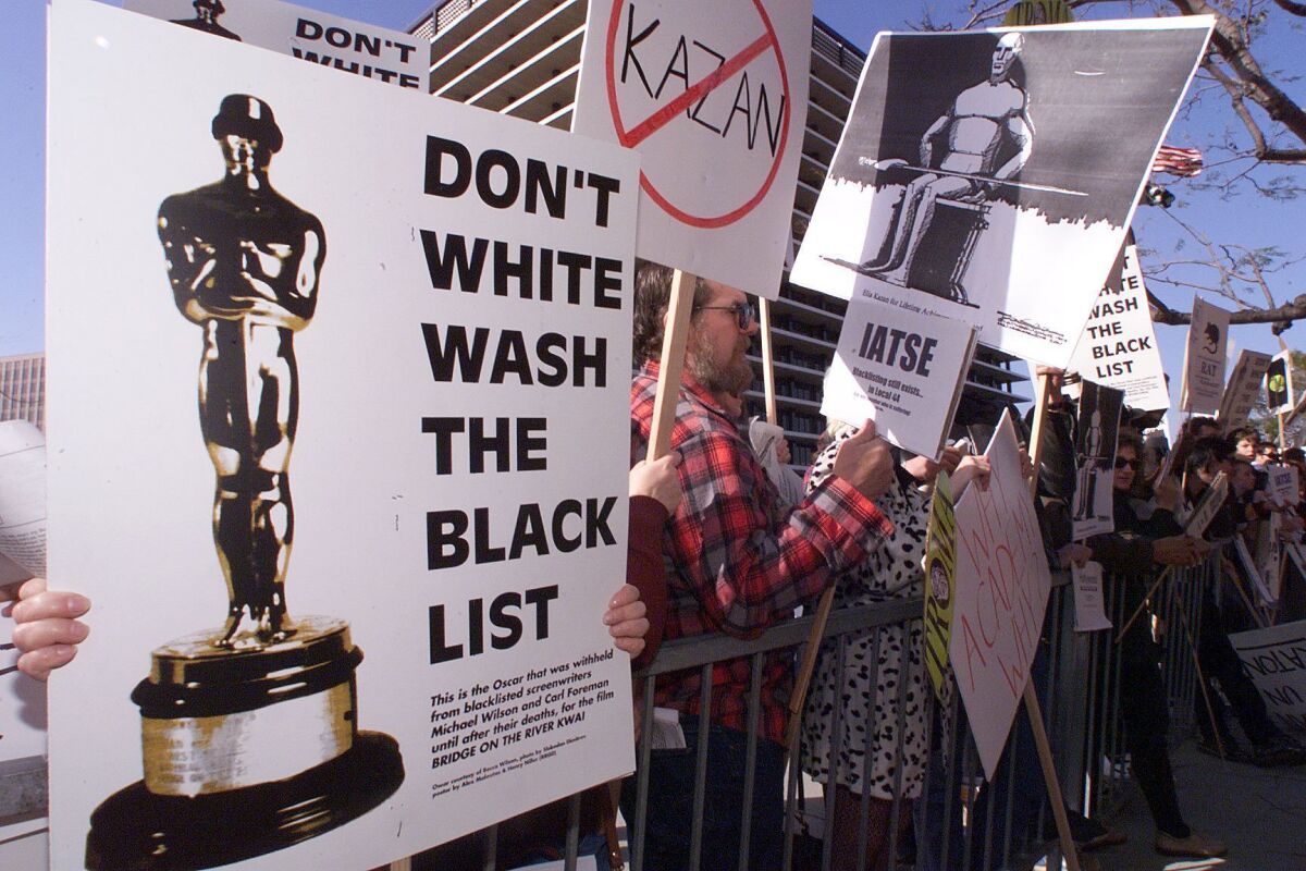 Protestors demonstrate March 21, 1999, in Los Angeles against the Lifetime Achievement Award to be presented to film director Elia Kazan during the 71st annual Academy Awards.