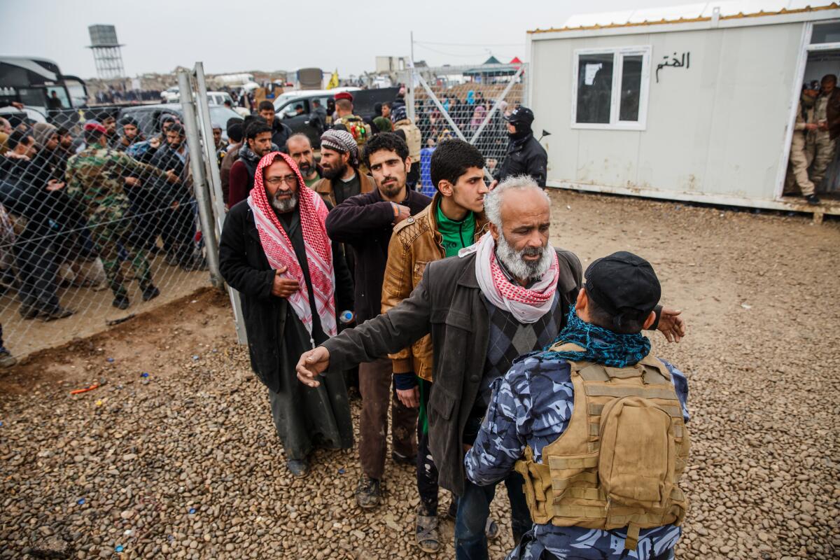 Incoming civilians to Hammam Al-Alil camp are checked for weapons as part of Community Policing's effort to screen for ISIS members.