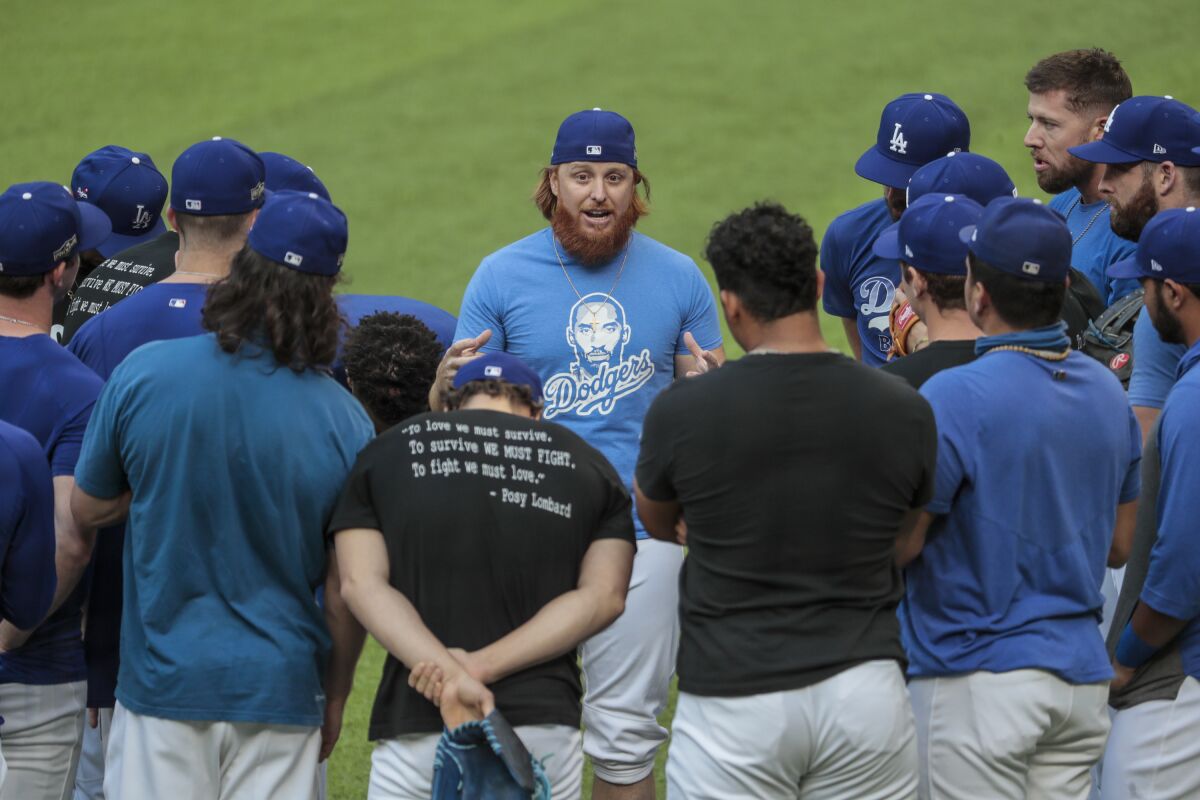 Dodgers third baseman Justin Turner delivers talks with teammates.