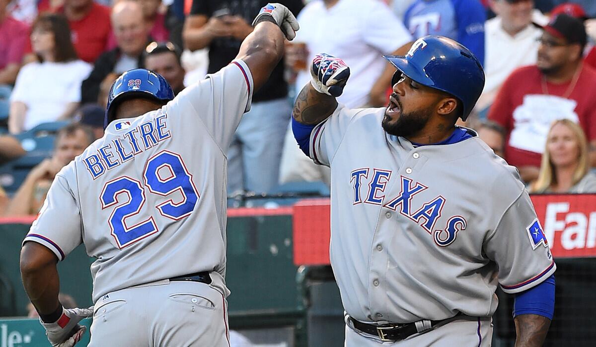 Texas Rangers' Adrian Beltre, left, is greeted by Prince Fielder after a solo home run in the first inning against the Angels on July 18.