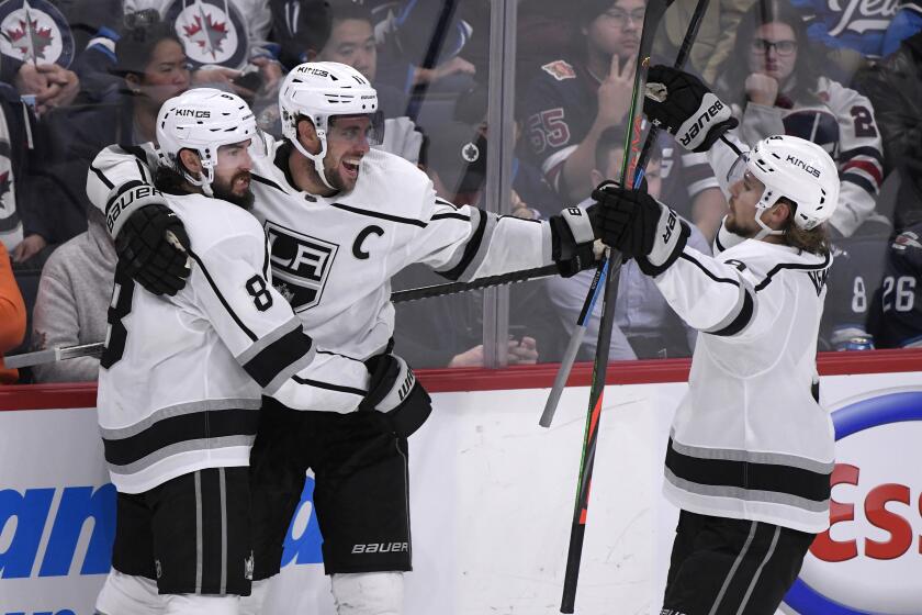 Los Angeles Kings' Anze Kopitar (11) celebrates his goal against the Winnipeg Jets with Drew Doughty (8) and Adrian Kempe (9) during the third period of an NHL hockey game Tuesday, Oct. 22, 2019, in Winnipeg, Manitoba. (Fred Greenslade/The Canadian Press via AP)