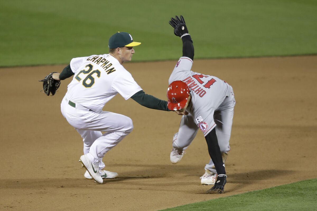 The Athletics' Matt Chapman tags out the Angels' Shohei Ohtani during the 10th inning July 24, 2020.