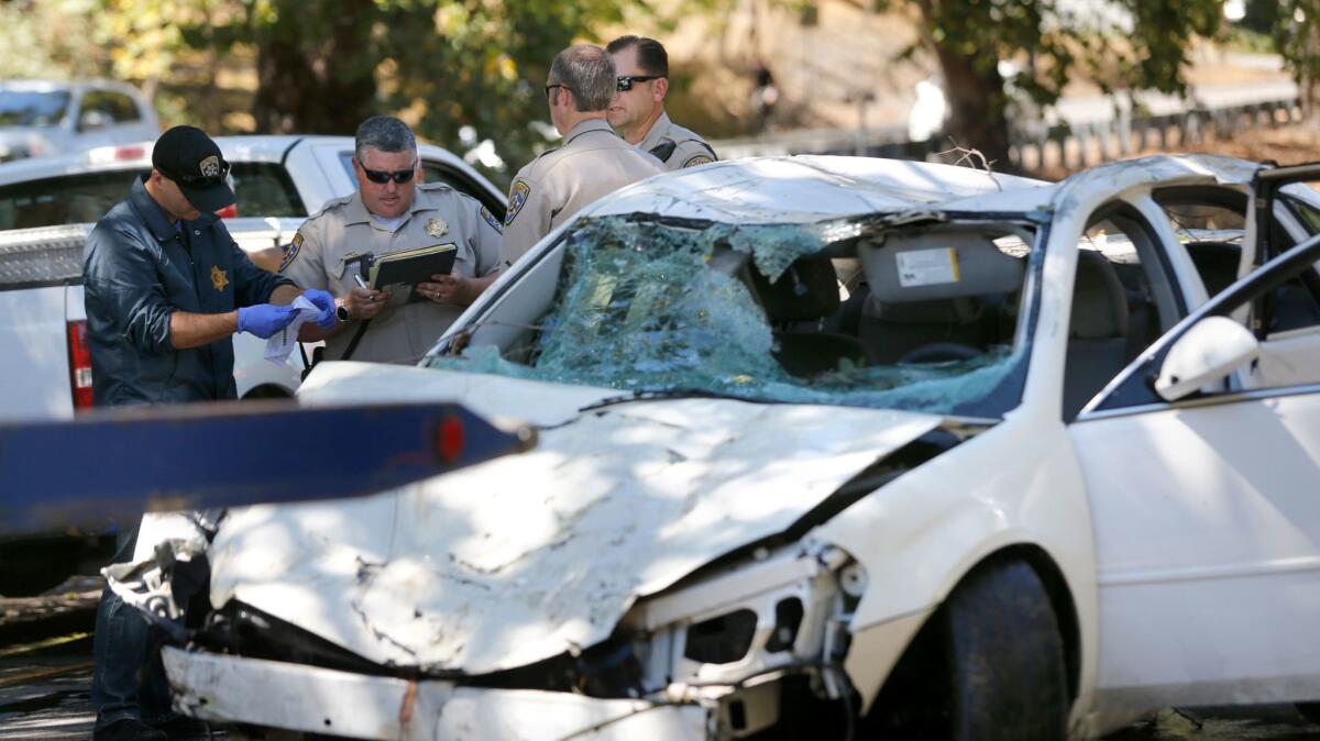 California Highway Patrol officers examine a car after it was removed from the Petaluma River following an accident that left two young sisters dead. Their mother, Alejandra Hernandez, has been arrested in connection with their deaths.