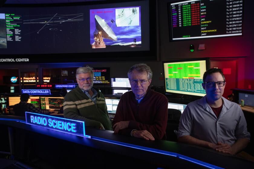 PASADENA, CA - FEBRUARY 07: Lance Benner, principal scientist, left; Paul Chodas, Director of Center for Near-Earth Object Studies (CNEOS) and Mark Haynes, radar system engineer at the Jet Propulsion Laboratory are studying the 1100-foot wide asteroid Apophis that will come within viewing distance of Earth on April 13, 2029. This will be one of the best opportunities to learn about the formation of the solar system and how we might defend ourselves as a planet against an asteroid strike in the future. Photographed at the Jet Propulsion Laboratory on Tuesday, Feb. 7, 2023. (Myung J. Chun / Los Angeles Times)