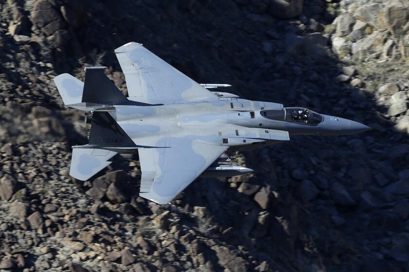In this Feb. 28, 2017, photo, an F-15C Eagle from the California Air National Guard, 144th Fighter Wing, flies through the nicknamed Star Wars Canyon over Death Valley National Park, Calif. Military jets roaring over national parks have long drawn complaints from hikers and campers. But in California's Death Valley, the low-flying combat aircraft skillfully zipping between the craggy landscape has become a popular attraction in the 3.3 million acre park in the Mojave Desert, 260 miles east of Los Angeles. (AP Photo/Ben Margot)