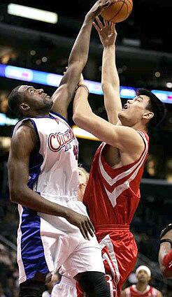 NOT HERE: The Clippers' Elton Brand blocks a shot by Houston's Yao Ming during the first quarter Tuesday night at Staples Center.
