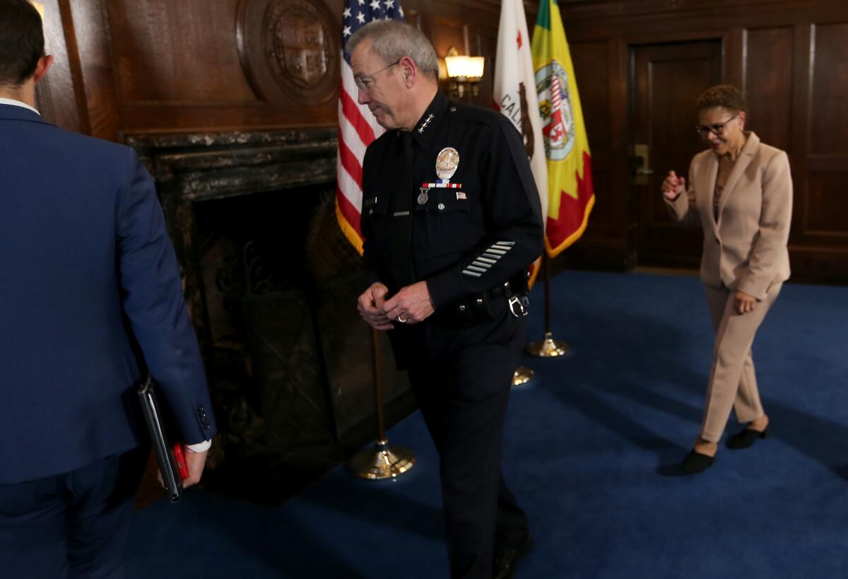 Los Angeles Police Department Chief Michel Moore, center, and Mayor Karen Bass, right, 