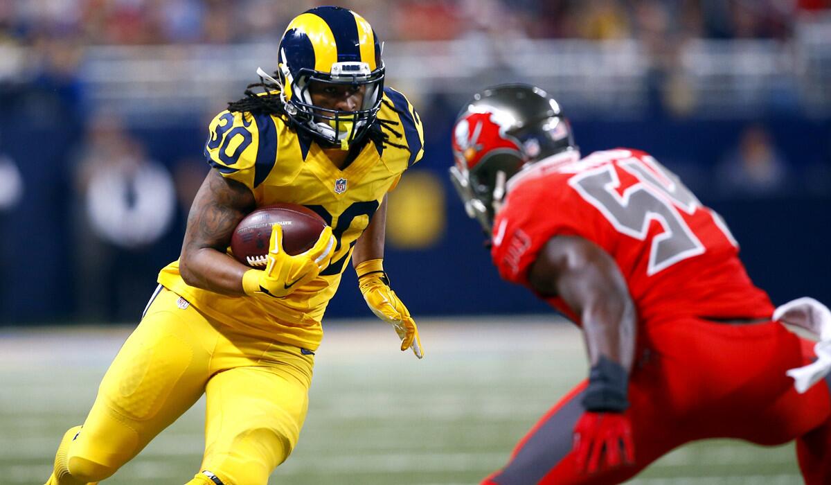 St. Louis Rams running back Todd Gurley, left, carries the ball as Tampa Bay Buccaneers outside linebacker Lavonte David defends during the second quarter on Thursday.