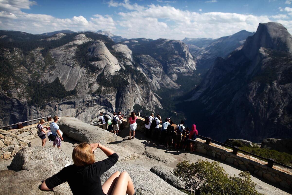 Tourists enjoy the grand view at Glacier Point in Yosemite National Park on Aug. 27, 2013.