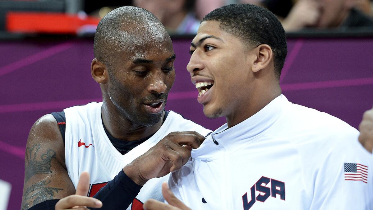 Lakers star Kobe Bryant, left, and New Orleans Pelicans forward Anthony Davis talk while sitting on the bench during a game at the 2012 London Olympics.