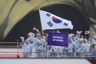 The boat carrying team South Korea makes its way down the Seine in Paris, France, during the opening ceremony of the 2024 Summer Olympics, Friday, July 26, 2024. (AP Photo/Rebecca Blackwell)