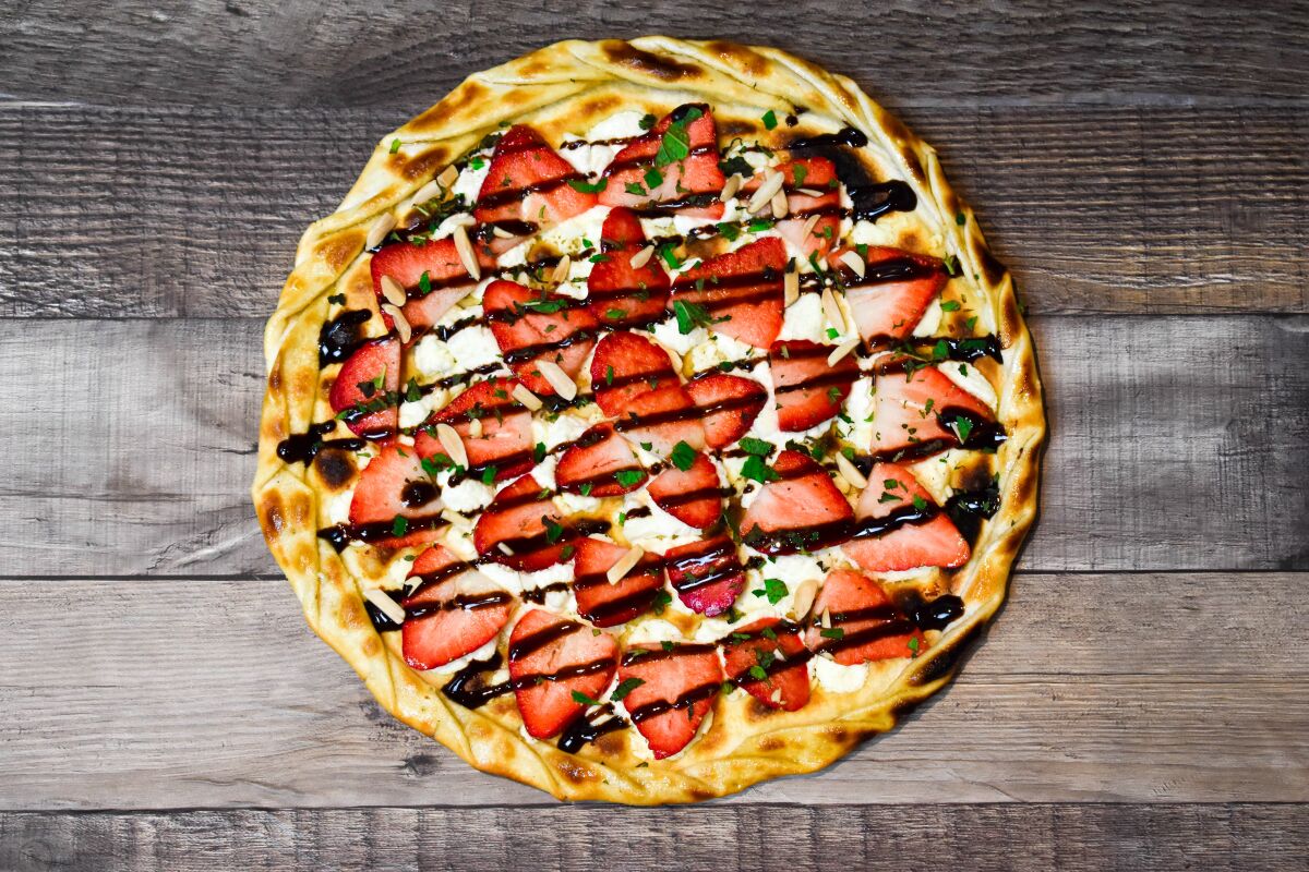 Sammy's Lover's Delight dessert pizza is made with goat cheese, chili oil, fresh strawberries, almonds, fresh basil and chocolate drizzle on a crispy, French-style crust. The special is available through the end of the month. 