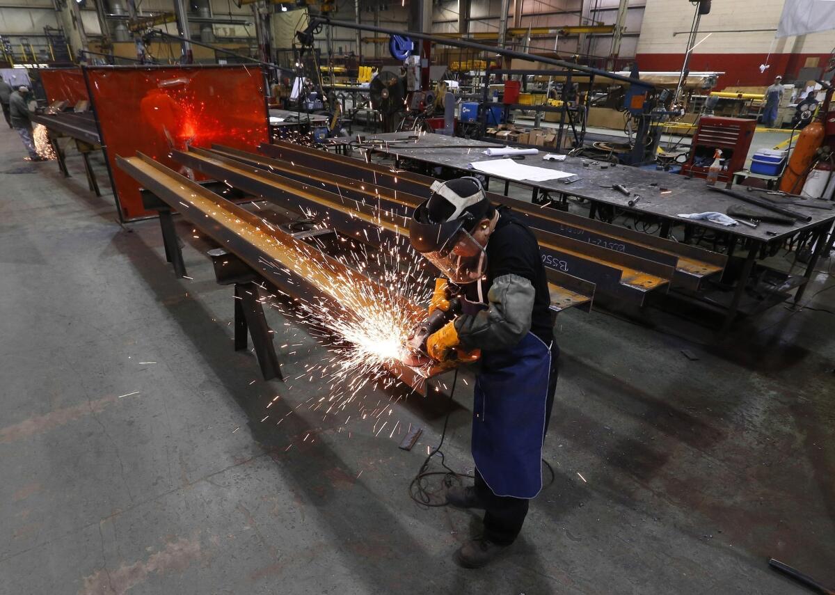 Jesus Rodriguez grinds steel at the IDEAL Group factory in Detroit.