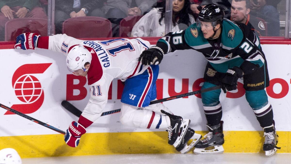 Montreal Canadiens' Brendan Gallagher takes a hit from Ducks' Brandon Montour during the second period on Tuesday.
