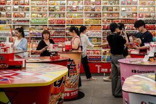 People shop and eat in the dining area at a CU convenience store in Seoul.