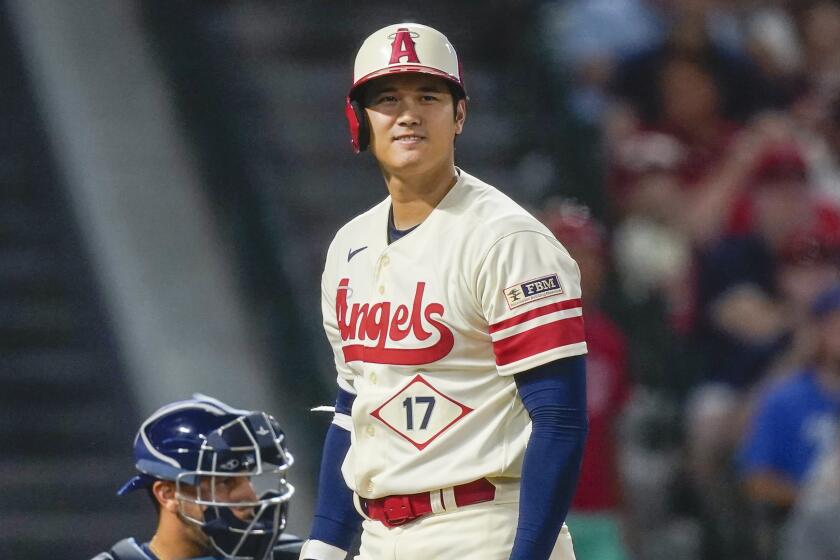Los Angeles Angels designated hitter Shohei Ohtani reacts after swinging.