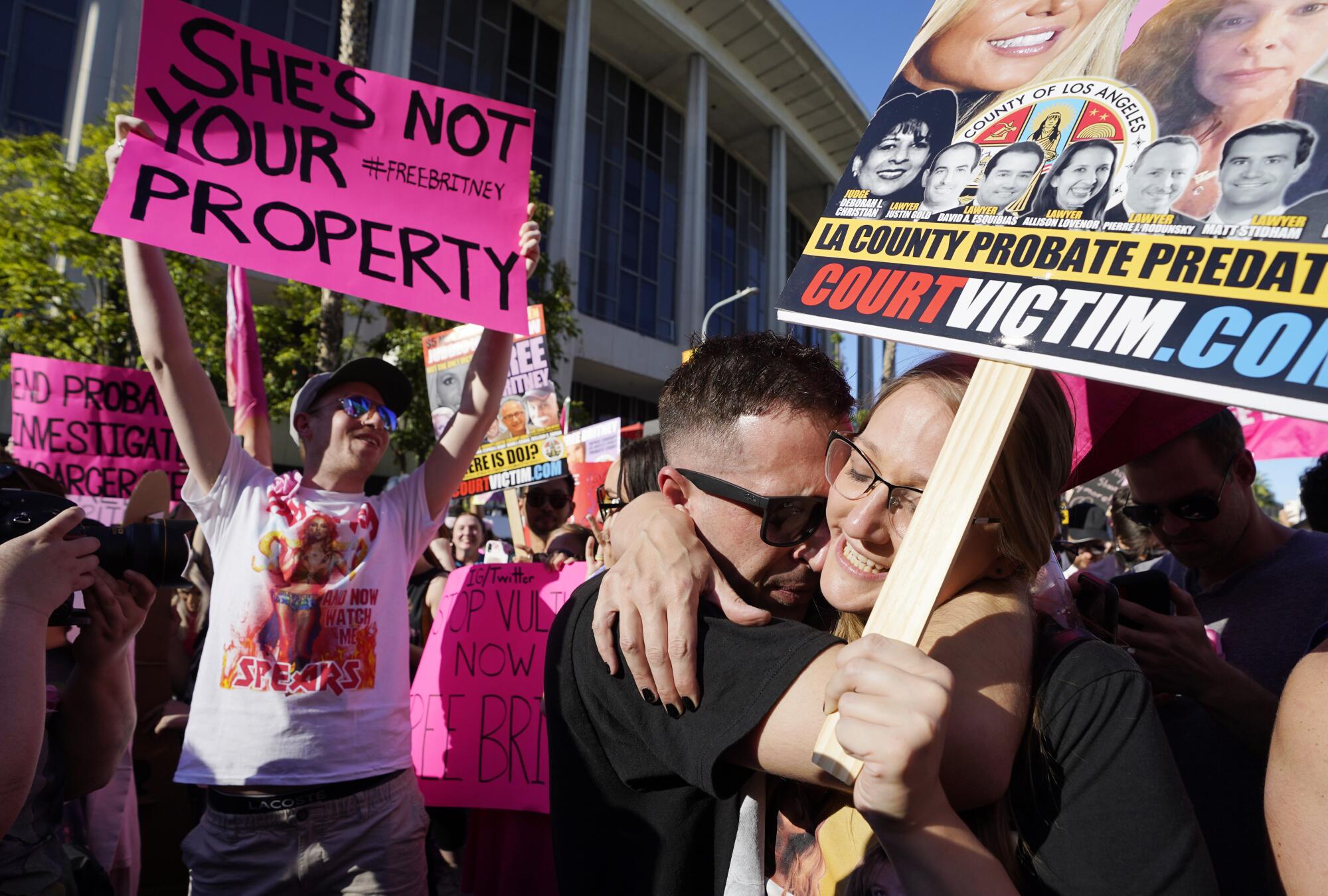 Britney Spears supporters Aaron Morris, second from right, and Elizabeth Crocker embrace