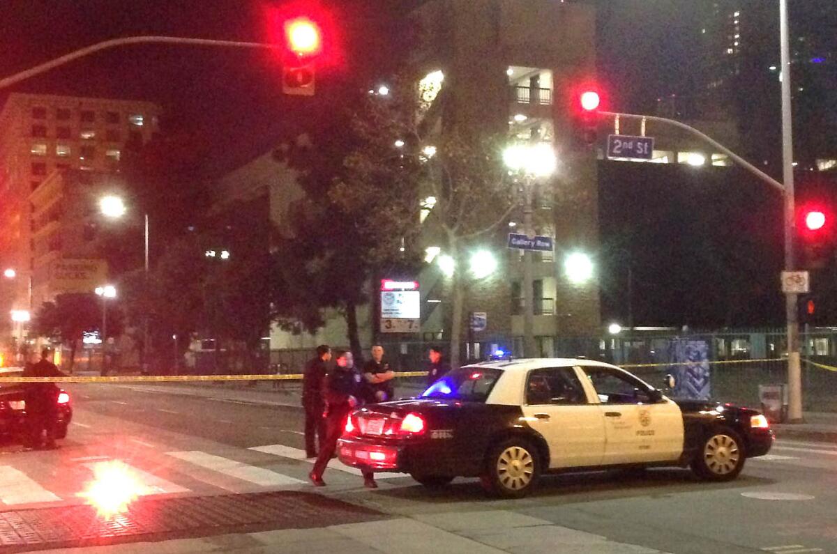 A police car blocks off Spring Street at 2nd Street in downtown Los Angeles during a bomb scare on Dec. 28.