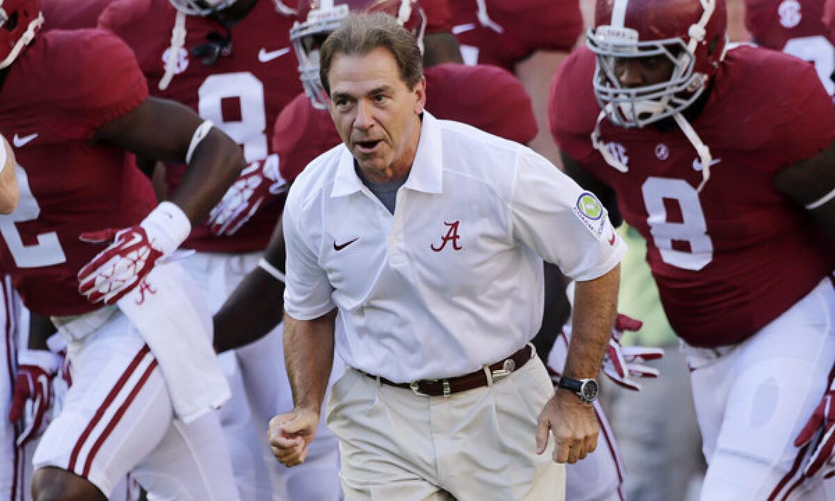 Alabama Coach Nick Saban leads his team onto the field before a 2013 game against Mississippi. Saban has been one of the most vocal supporters of a proposed new college football rule that would penalize teams that snap the ball before 10 seconds have passed on the 40-second play clock.