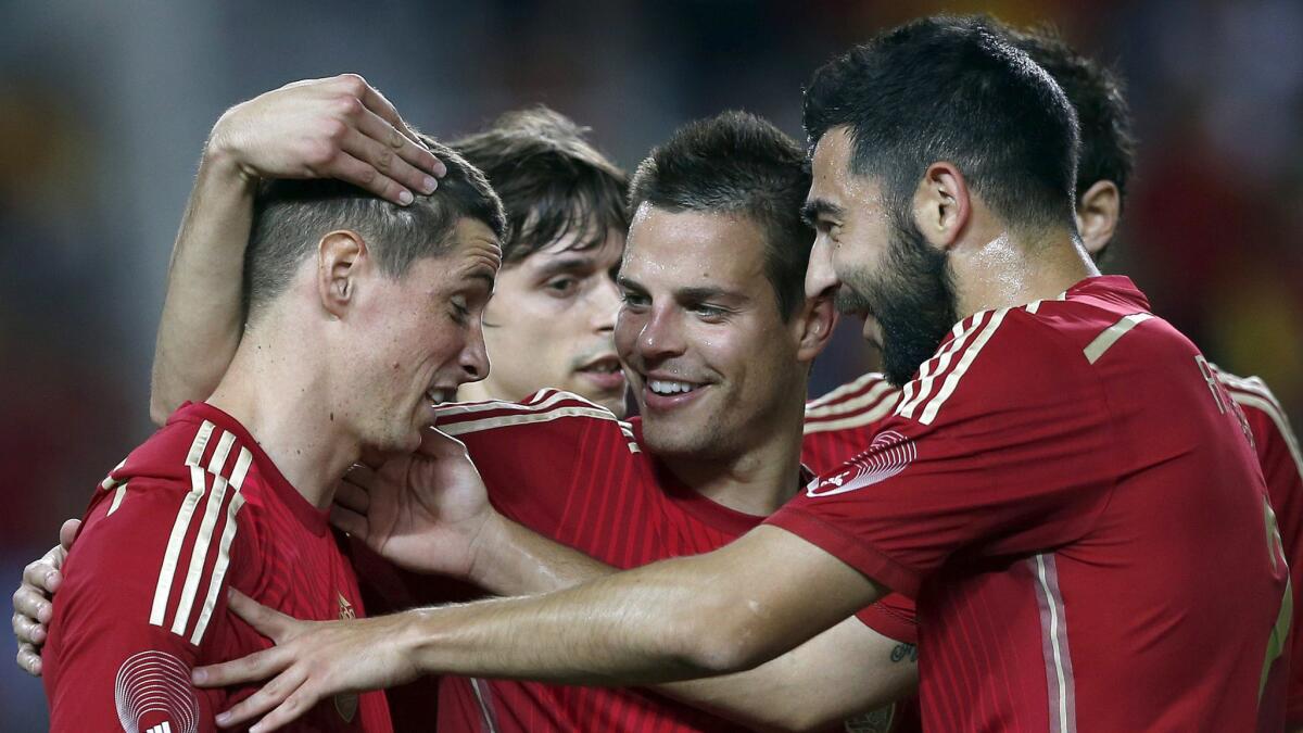 Spain's Fernando Torres, left, celebrates with his teammates after scoring during an international friendly match against Bolivia on Friday. Spain Coach Vicente del Bosque worries that his players' busy club schedules have had a detrimental effect on their World Cup preparations.