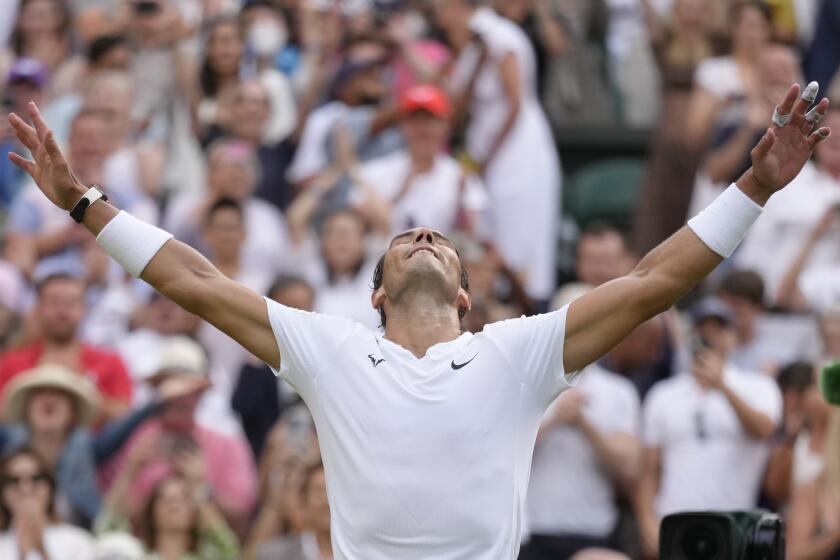 Spain's Rafael Nadal celebrates after beating Taylor Fritz of the US in a men's singles quarterfinal match at Wimbledon