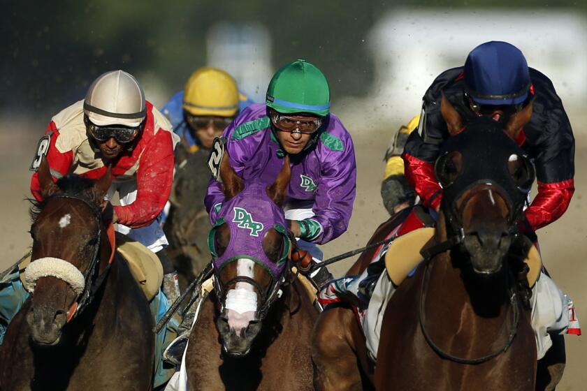 California Chrome, center, is flanked by Wicked Strong, left, and Tonalist, right, as they head down the backstretch of the Belmont Stakes. Tonalist went on to win, denying California Chrome the Triple Crown.