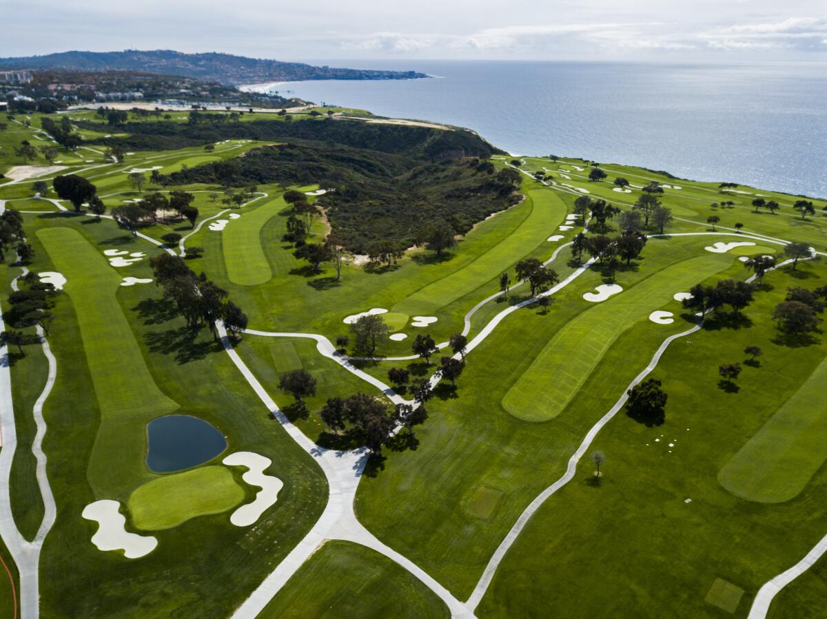 An aerial view of an oceanside golf course.