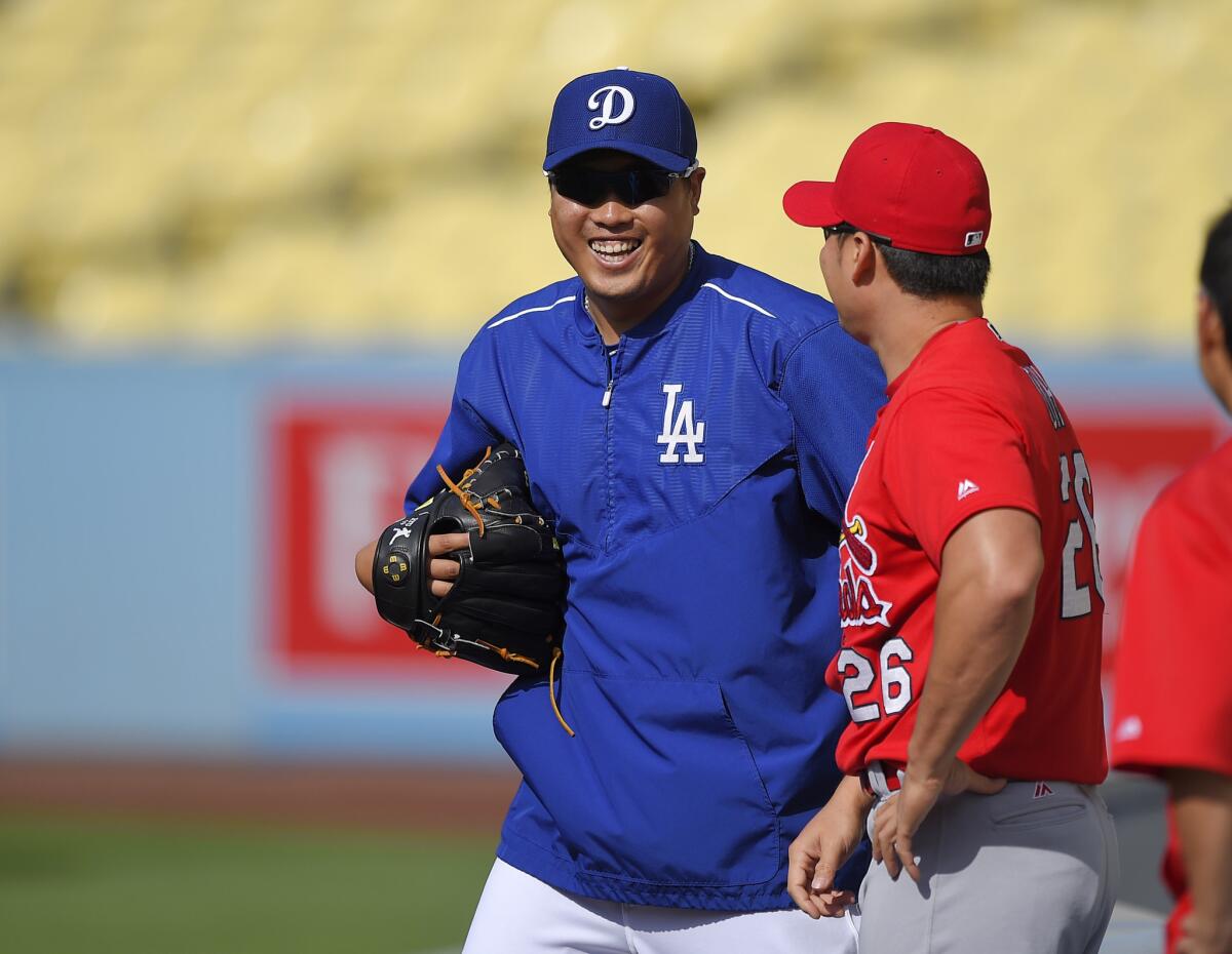 Dodgers pitcher Hyun-Jin Ryu talks with the St. Louis Cardinals' Seung-Hwan Oh before a game on May 13.