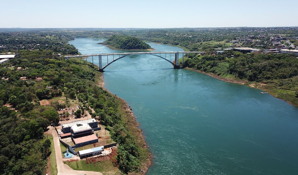 The Friendship Bridge spans over the Parana river along the border of Brazil, right, with Paraguay, left, Wednesday, Oct. 13, 2021. The gigantic Itaipu hydroelectric dam straddling the Brazil-Paraguay border is feeling the heat of Brazil’s worst drought in nine decades, with power output at its lowest level since 1994. (AP Photo/Emilio Sanabria)