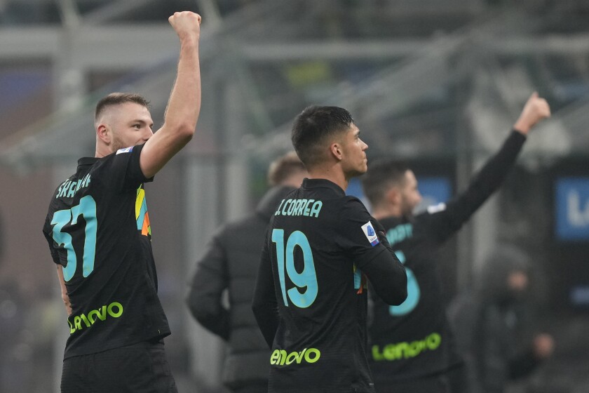 Inter Milan's players celebrate at the end of the Serie A soccer match between Inter Milan and Lazio at the San Siro Stadium, in Milan, Italy, Sunday, Jan. 9, 2022. (AP Photo/Antonio Calanni)