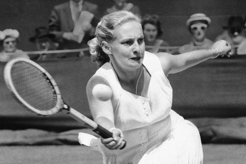 FILE - Darlene Hard hits a forehand to Zsuzsa Kormoczy during a quarterfinal on June 28, 1955.