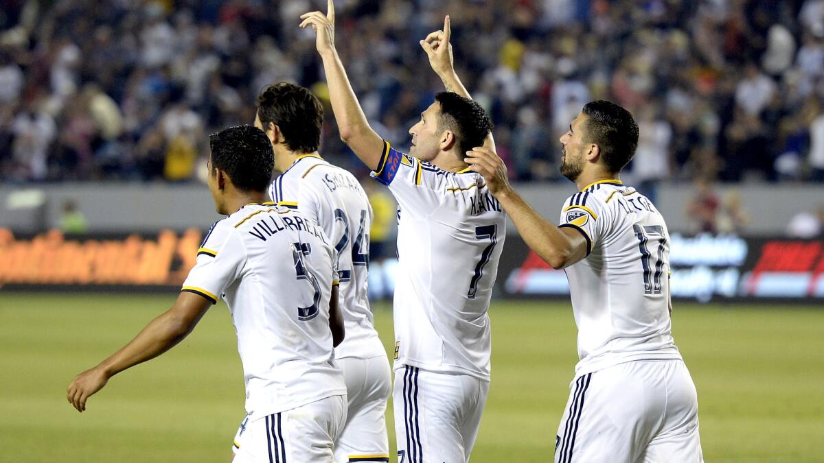 Galaxy forward Robbie Keane (arms raised) celebrates with teammates after scoring his third goal in a 4-0 victory over Toronto on Saturday night at StubHub Center.