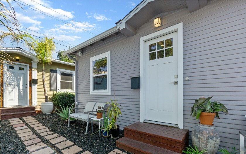 House with large door and walkway at left