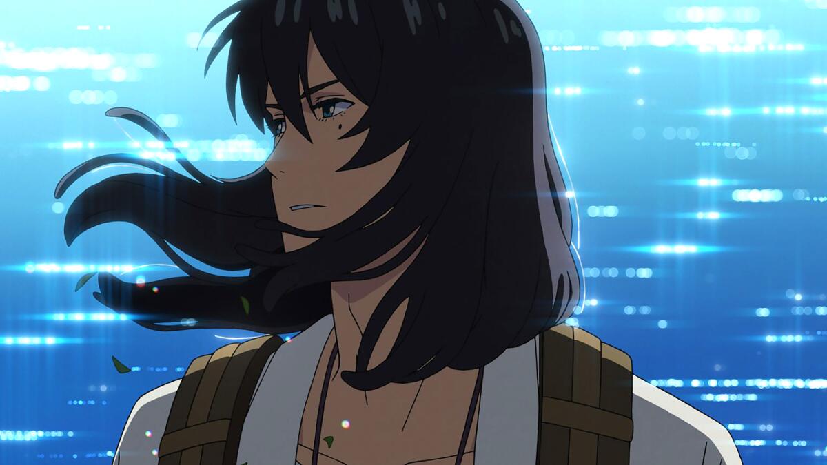 A young man stands near the ocean, hair blowing in the breeze in the animated "Suzume."