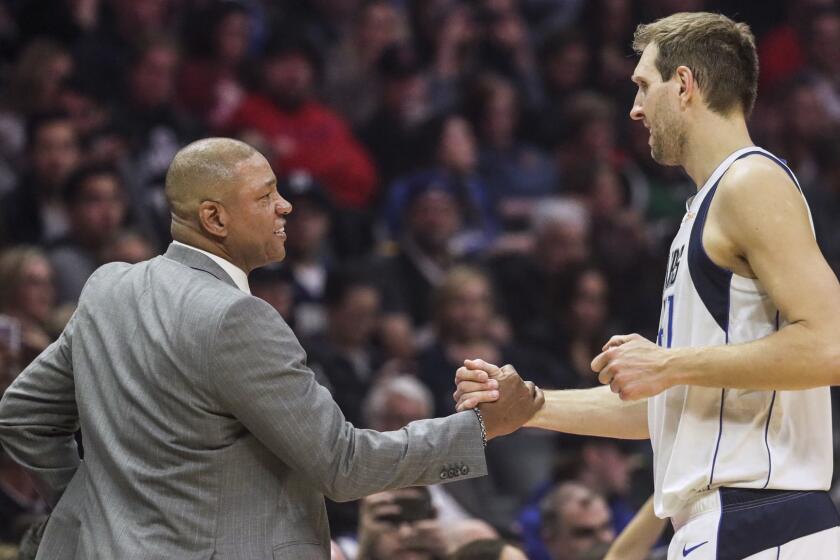 LOS ANGELES, CA, MONDAY, FEBRUARY 25, 2019 - Clippers coach Doc Rivers greets Mavericks forward Dirk Nowitzki during a break in the action at Staples Center. (Robert Gauthier/Los Angeles Times)