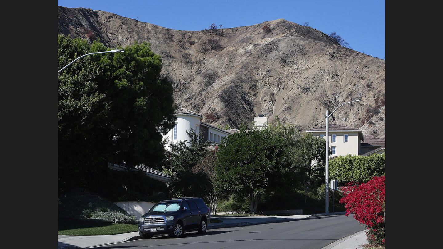 Photo Gallery: Burbank homes with burned out mountains behind them working with Los Angeles County Department of Public Works and the U.S. Department Agriculture to help residents prepare for potential mudslides