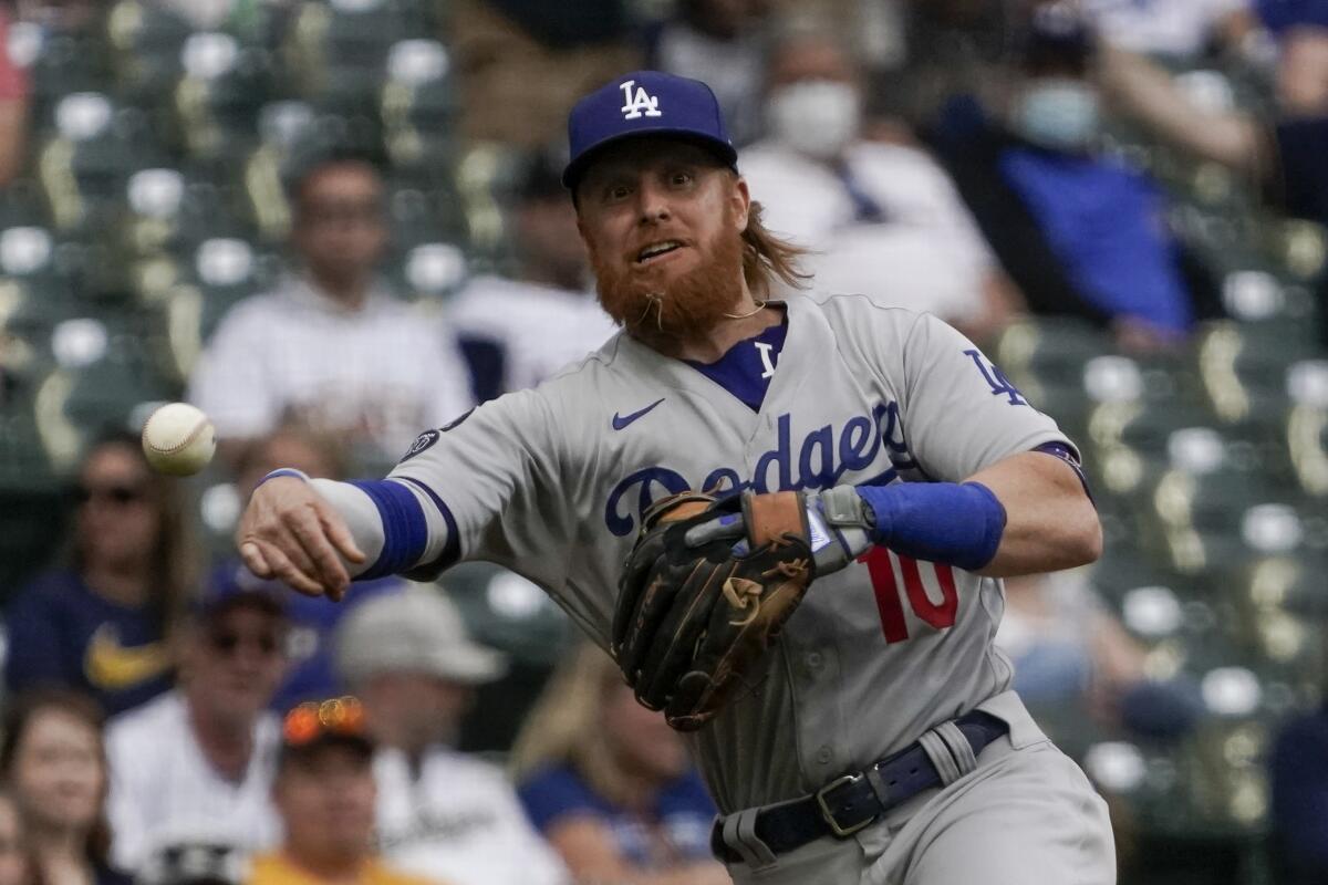 Dodgers third baseman Justin Turner throws to first against the Brewers on Saturday.