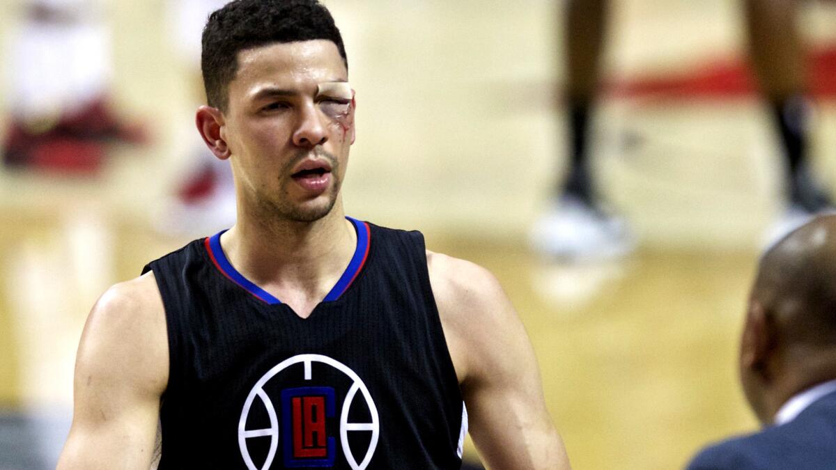 Clippers guard Austin Rivers, who sustained a gash over his left eye in the first half, heads to the bench during a break in play in the second half.