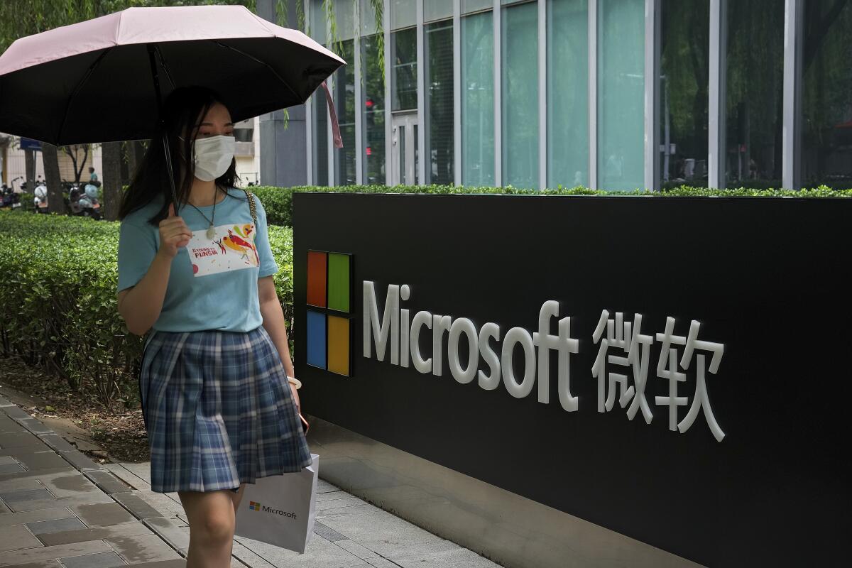 Woman walking by Microsoft building in Beijing