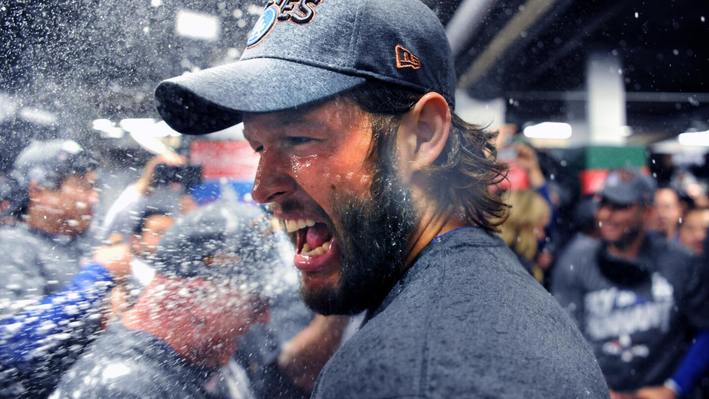 Clayton Kershaw celebrates with champagne in the clubhouse after the Dodgers won the National League pennant.
